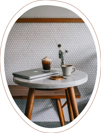 Mac and coffee on a small table