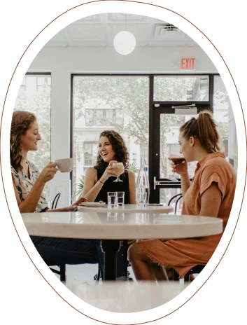 Three women chatting while drinking coffee